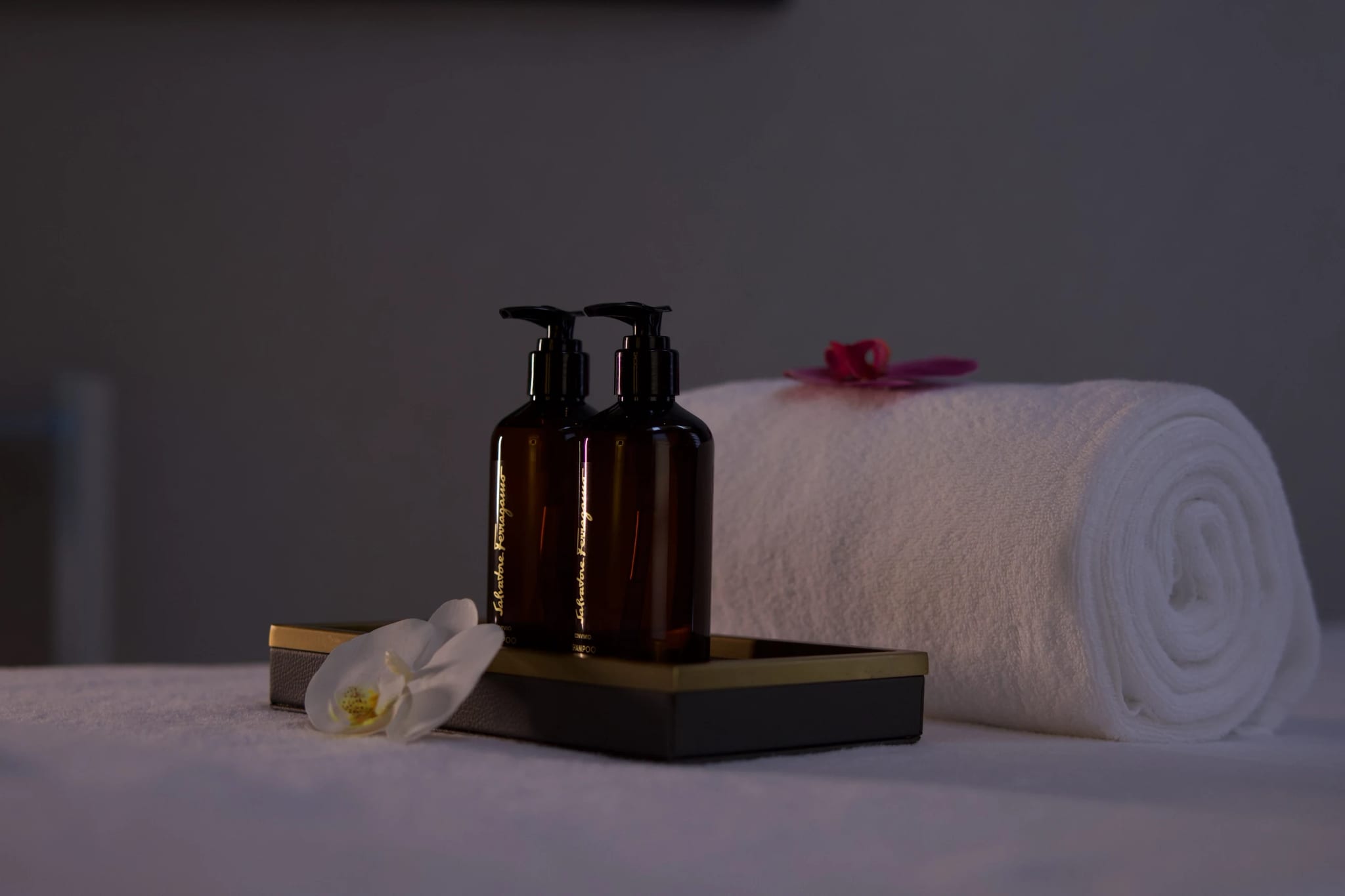 Amenities and a rolled towel on a treatment table at the spa, Sariya Hotel